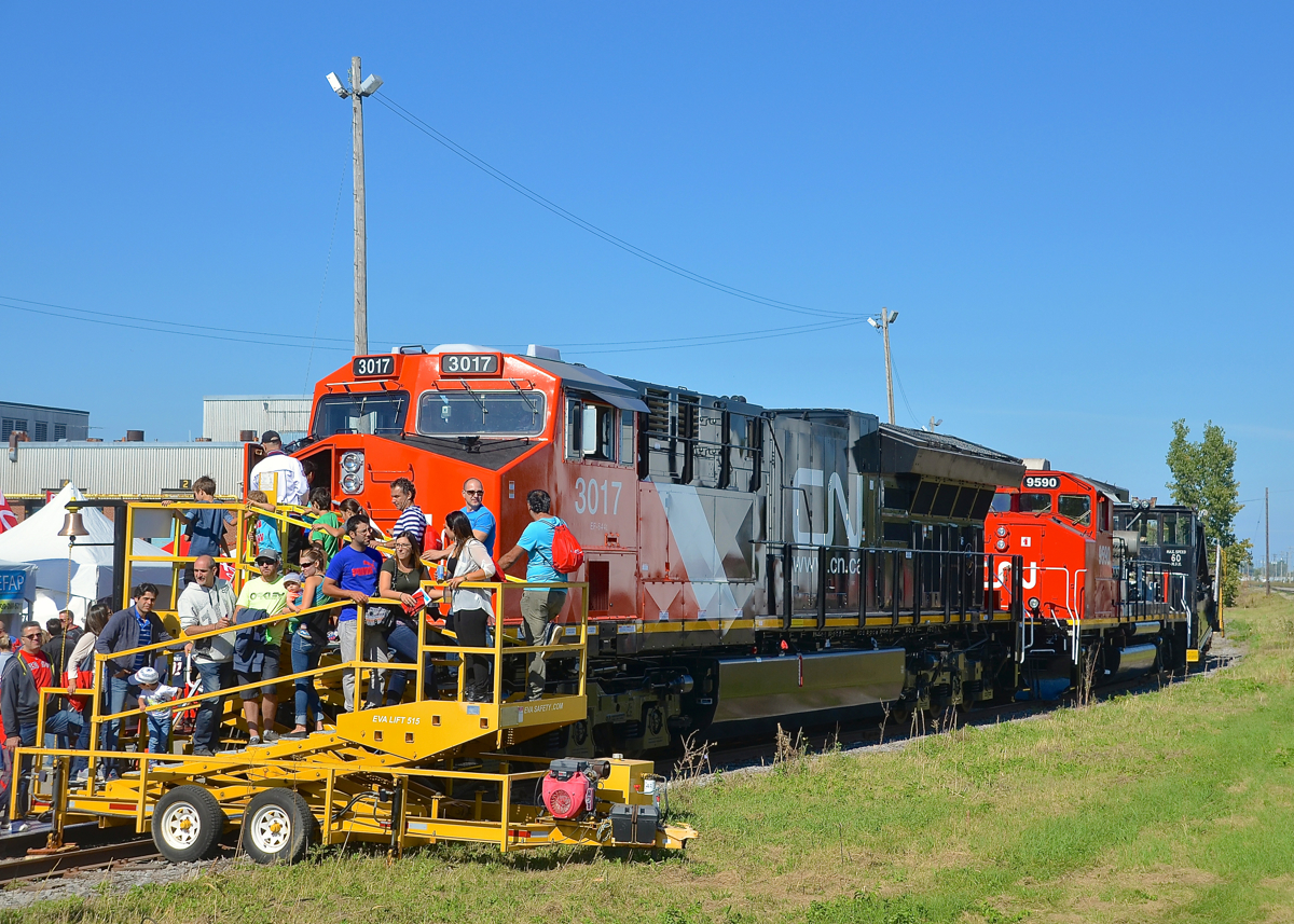 CN family day at Taschereau Yard.As part of CN family day in Montreal today, brand new ET44AC CN 3017 is open for display. Behind it is GP40-2(W) CN 9591 (with no hood and its prime mover fully exposed) and Jordan spreader 50951.