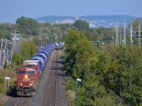 <b>A windmill train around the curve.</b> On a gorgeous and warm fall afternoon, a pair of CP ES44AC's lead a windmill train around a curve in Pointe-Claire, with windmill towers bound for Iowa.