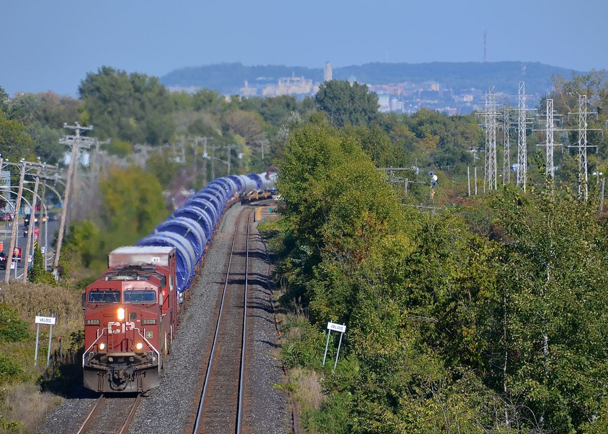 A windmill train around the curve. On a gorgeous and warm fall afternoon, a pair of CP ES44AC's lead a windmill train around a curve in Pointe-Claire, with windmill towers bound for Iowa.