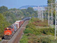 <b>A high headlight SD70M-2 leading.</b> One of CN's high headlight SD70M-2's (CN 8011) leads another, later SD70M-2 (CN 8926) as CN 377 rounds a curve in Pointe-Claire, with Mount-Royal in the background.