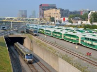 <b>Airport shuttles on two levels.</b> An inbound Union Pearson Express train is below as an outbound train passes above, going from and to Pearson Airport. At right is the GO North Bathurst Yard.