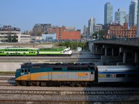 <b>VIA & GO Transit west of Union Station.</b> VIA 6416 backs a deadhead movement east towards Union Station in Toronto. In the distance are a number of trains laying over in the GO North Bathurst Yard.