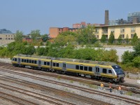 <b>Union Pearson shuttle passing some trackworkers.</b> A Union Pearson Express train passes some trackworkers just west of the Bathurst overpass.