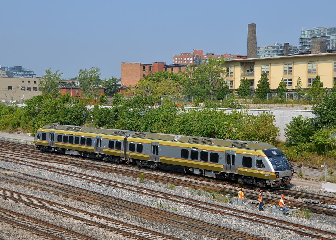 Union Pearson shuttle passing some trackworkers. A Union Pearson Express train passes some trackworkers just west of the Bathurst overpass.