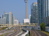 <b>Under the CN tower.</b> Cab car GOT 205 leads a westbound under the flyover a bit west of Union Station in Toronto. Dominating the scene is the CN tower.