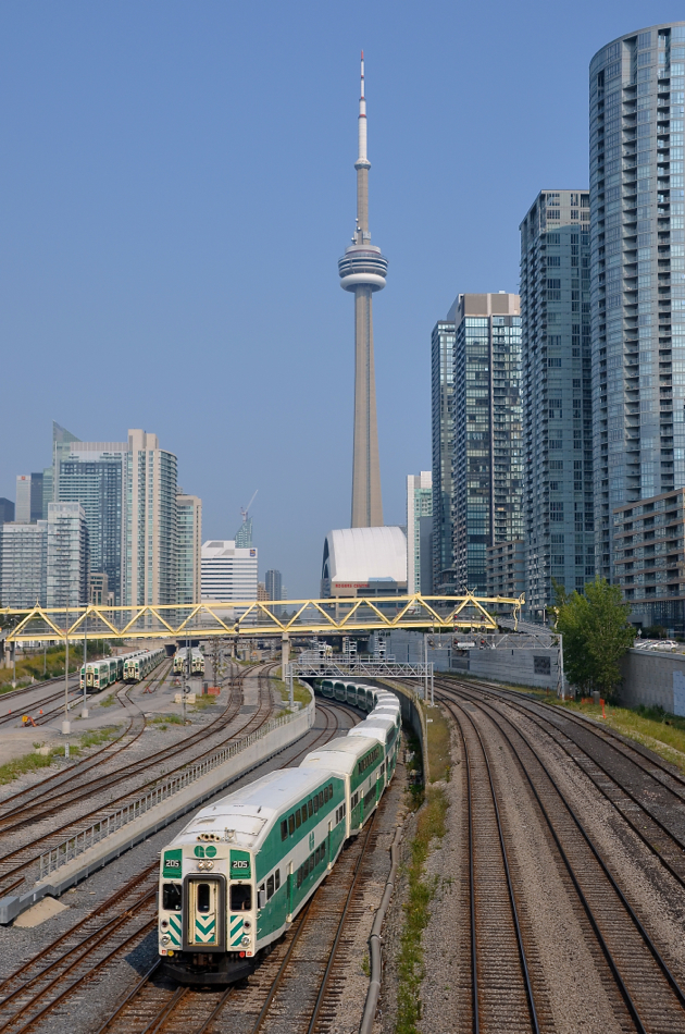 Under the CN tower. Cab car GOT 205 leads a westbound under the flyover a bit west of Union Station in Toronto. Dominating the scene is the CN tower.