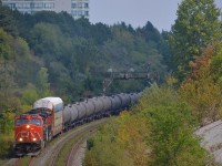 <b>Climbing the York Sub.</b> CN X318 with CN 2633 & CN 8856 passes the signals east of Hilda Avenue overpass. While this is an eastbound train, it is geographically westbound at this point, as it takes the York Sub to get from the Bala Sub to MacMillan Yard. 