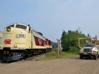 <b>Ontario Southland Railway, on the rails and on the road.</b> Freshly repainted FP9A OSRX 6508 is leading GP9 OSRX 1620 as they head light to pick up some cars at Putnam. Waiting at the crossing is an Ontario Southland Railway hi-railer.