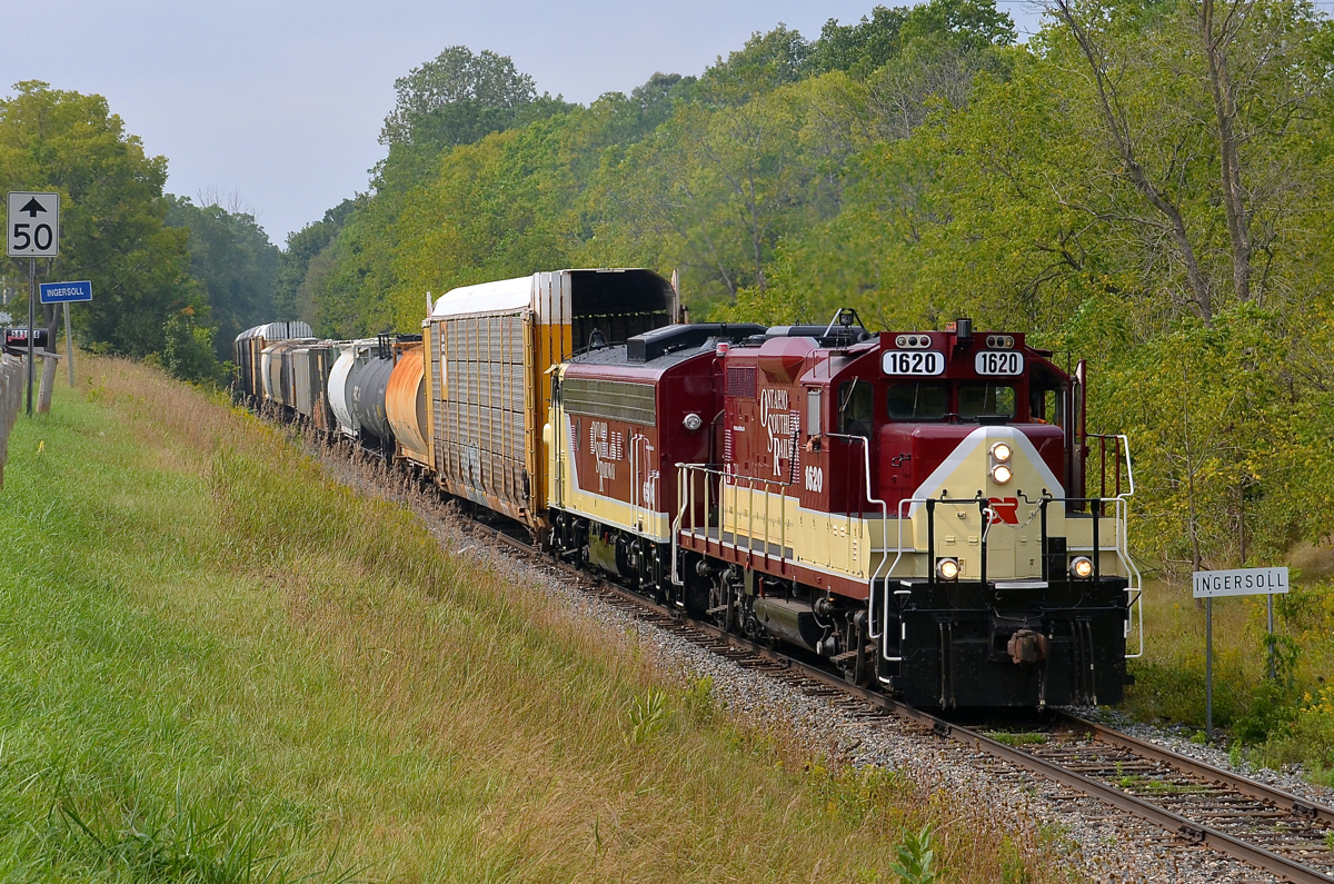 Matched vintage GMD power. After picking up cars at Putnam and Ingersoll, the OSR Woodstock job is heading to Woodstock to interchange with CP as it leaves Ingersoll. Power is a pair of vintage GMD products in matching paint: GP9 1620 and FP9 6508.