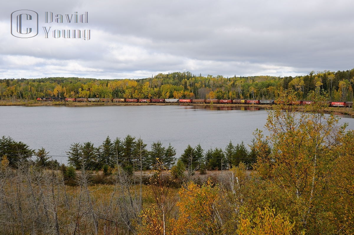 CN C44-9W 2639 and IC SD70 1034 lead grain empties along the shores of Mud Lake east of Kashabowie, Ontario. The train will skirt many little lakes like this while it traverses the rail of the Kashabowie, Fort Frances and Sprague Subs enroute to Winnipeg and points west to their final loading destination on the Canadian Prairie.