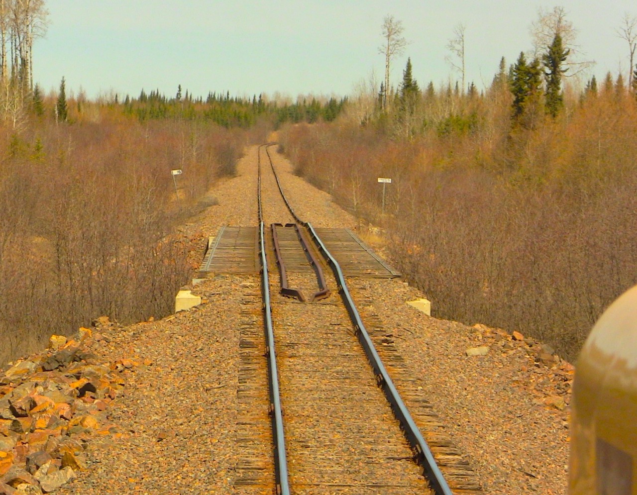 After lifting 30 or so car loads of phosphate from Agrium, 515 slows to a crawl for the less than favourable upcoming track conditions. Agrium mine as well as the Agrium subdivision closed shortly after this photo. Photo taken and uploaded with permission.