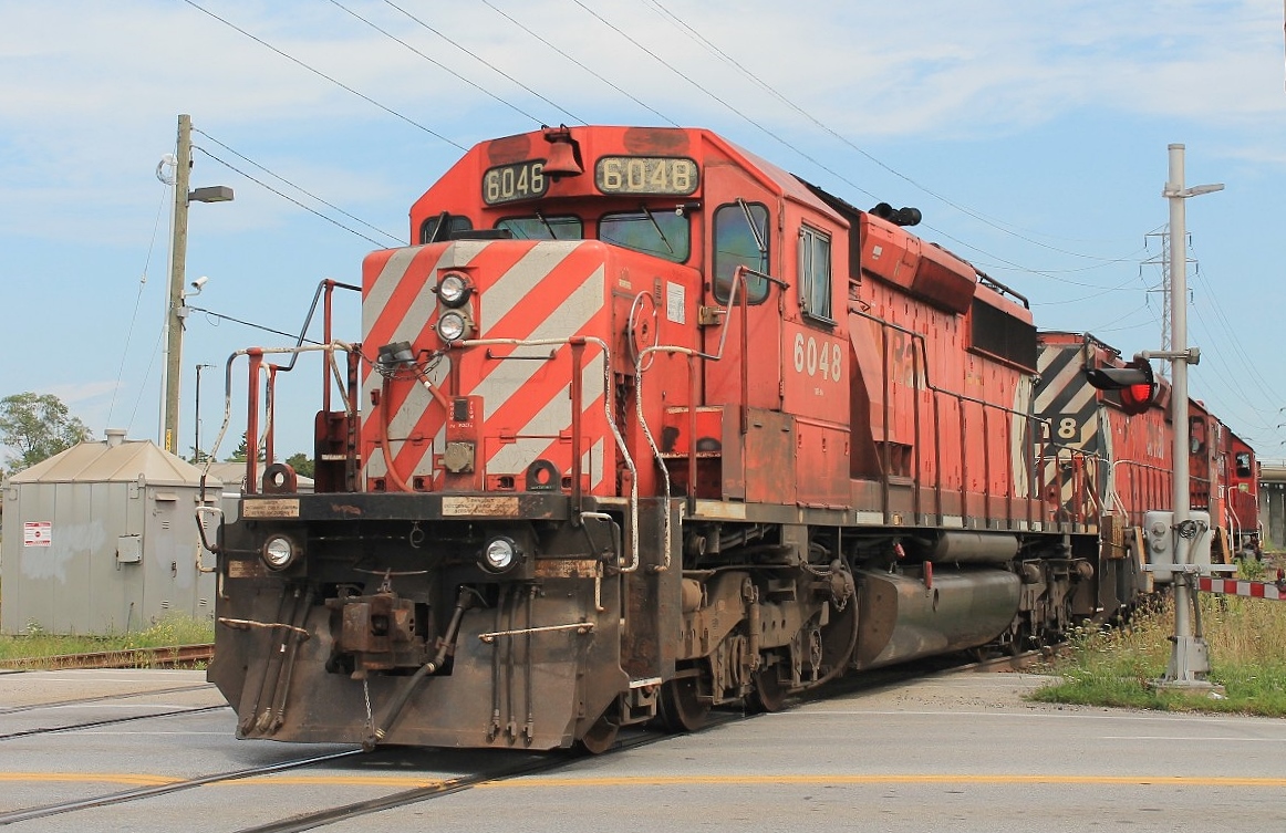 Multimarks the proper way. Two CP SD 40-2 6018 and 6048 follow CP 6257 with their multimarks next to each other. The locos have just returned light from the tunnel and are seen crossing Dougall Avenue on this very humid Saturday!