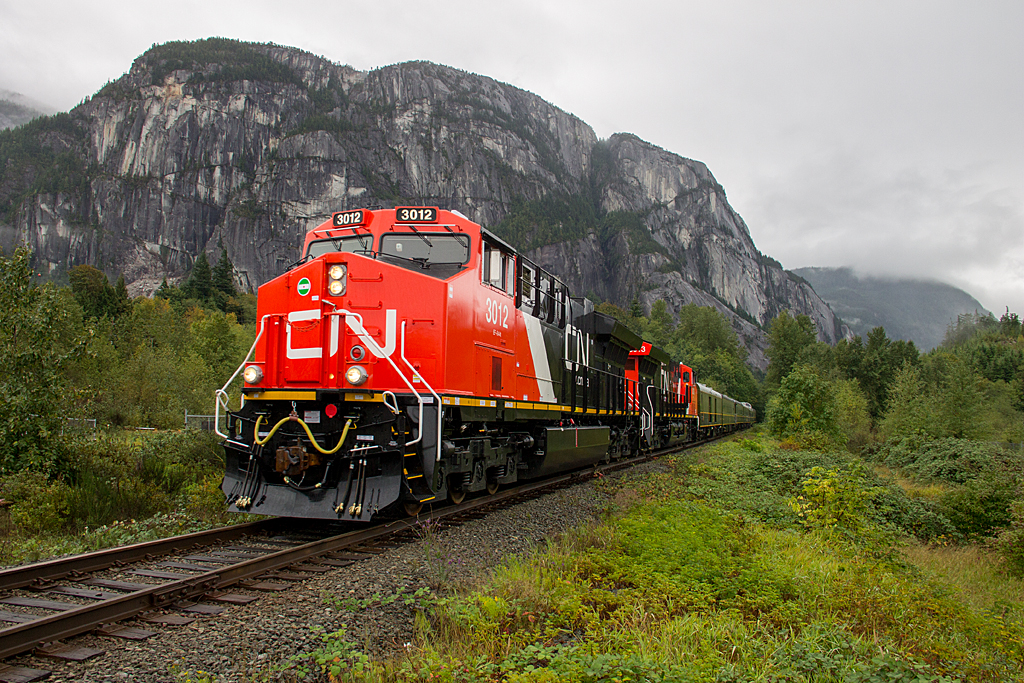 CNs business train recently did a tour of Western Canada from North Vancouver to Edmonton, which included the former BC Rail line. With the Stawamus Chief behind, the train is approaching Squamish with two of CNs newest ET44ACs at the helm of this six car train.