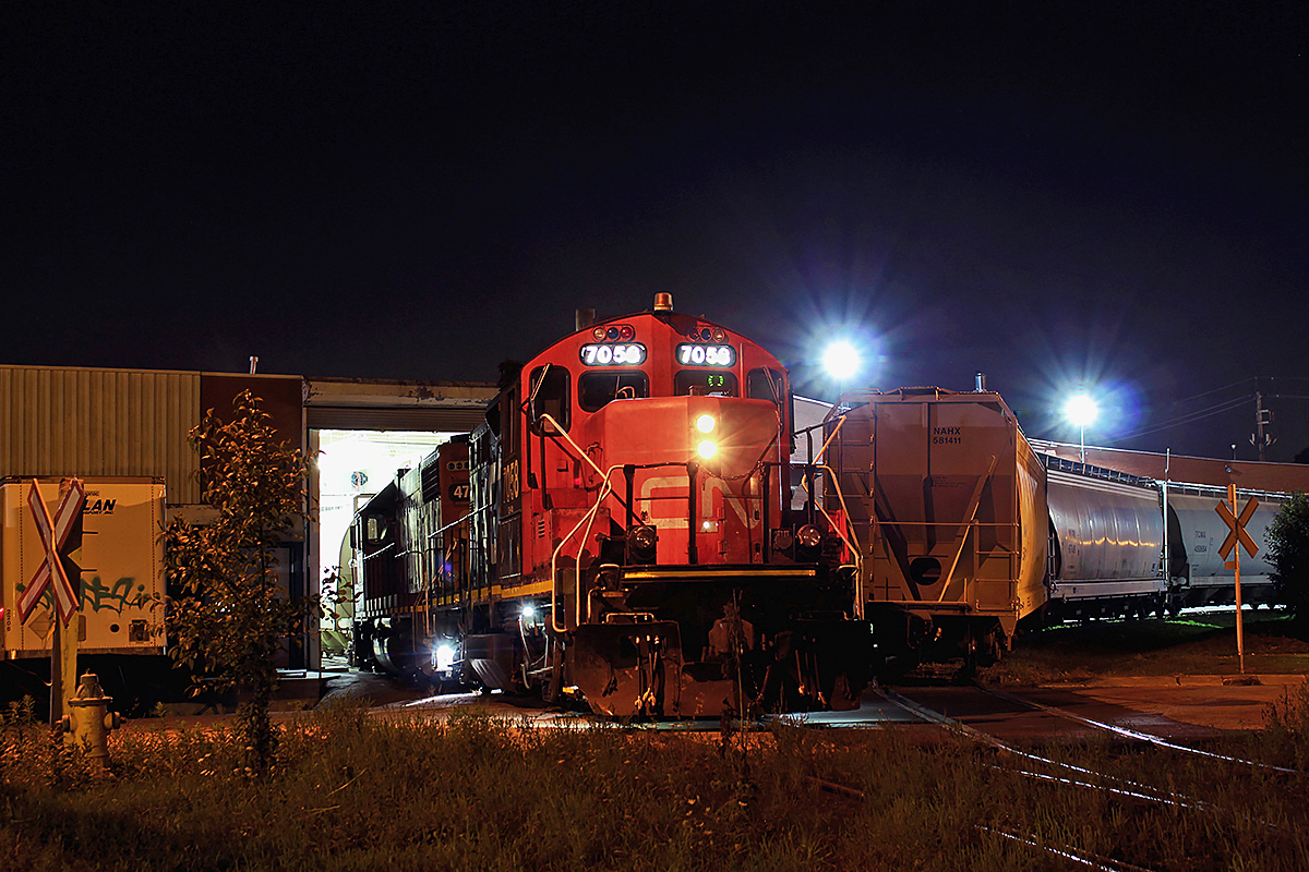 I think it's difficult to say which branchline in Toronto holds the strongest memories for me. Having lived in Scarborough for a bit when I was little, I remember this area well, but it's also been a long time since I've been to Golden Mile. Thanks to word from 546's crew the day before at Manse Valley, I made a trip up to the GECO branch to catch 546 early Thursday morning. Like the Port Lands spur, it is commonly believed the GECO is abandoned. Sadly, both are just skeletons of what they used to be. However, the GECO still receives a fair amount of business, including Home Lumber, Griffith Labs, and Ipex. Together, they were able to turn out about 12 cars. Here, 546 switches Griffith Labs with CN 7058, 4730. Griffith, having just opened the door to plant, has allowed 546 to back in to pick up a loaded hopper. On the other track is cars for Ipex. Once done at Griffith, 546 will pull out with the hopper, back onto the rest of the train on the right, pull forward, and back the last car into Griffith, which is an empty. The entire GECO job took about three and a half hours. Eventually, it picked up the rest of its train at the Birchmount runaround, and backed all the way onto the Uxbridge and back onto the Kingston Sub. After that, full throttle back to Oshawa. Again, like the Port Lands Spur, drivers that cross the GECO seem to think this line is abandoned. A driver, who saw the lights activate at Birchmount, must've thought the lights were malfunctioning, and got a rude surprise when 125 tons of metal started crossing the road. That driver hit the brakes pretty quickly. As said previously, Toronto still has some active industrial spurs left. As for the public, be aware and don't assume. If the top of the rails are the least bit shiny, they probably have seen recent use. As for railfans, look for that shine. Perhaps one day you'll get lucky. The last picture of the GECO on RP.ca I believe is from 1991. Come on guys... You're slacking. Then again, I don't know many railfans who want to foam in a rather sketchy neighborhood at 3am on a weekday night, so it's understandable.