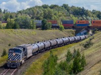 a Westbound freight from Moncton New Brunswick, (M305) makes its way through Beare up the grade on the York Sub, whilst an Eastbound CP, (CP142) is passing above. CN305 has a wonderful blue BCrail leading, with CN 2694 as mid DPU. 


First time experiencing a meet like this, and having a BCOL on point made it that much more special. 