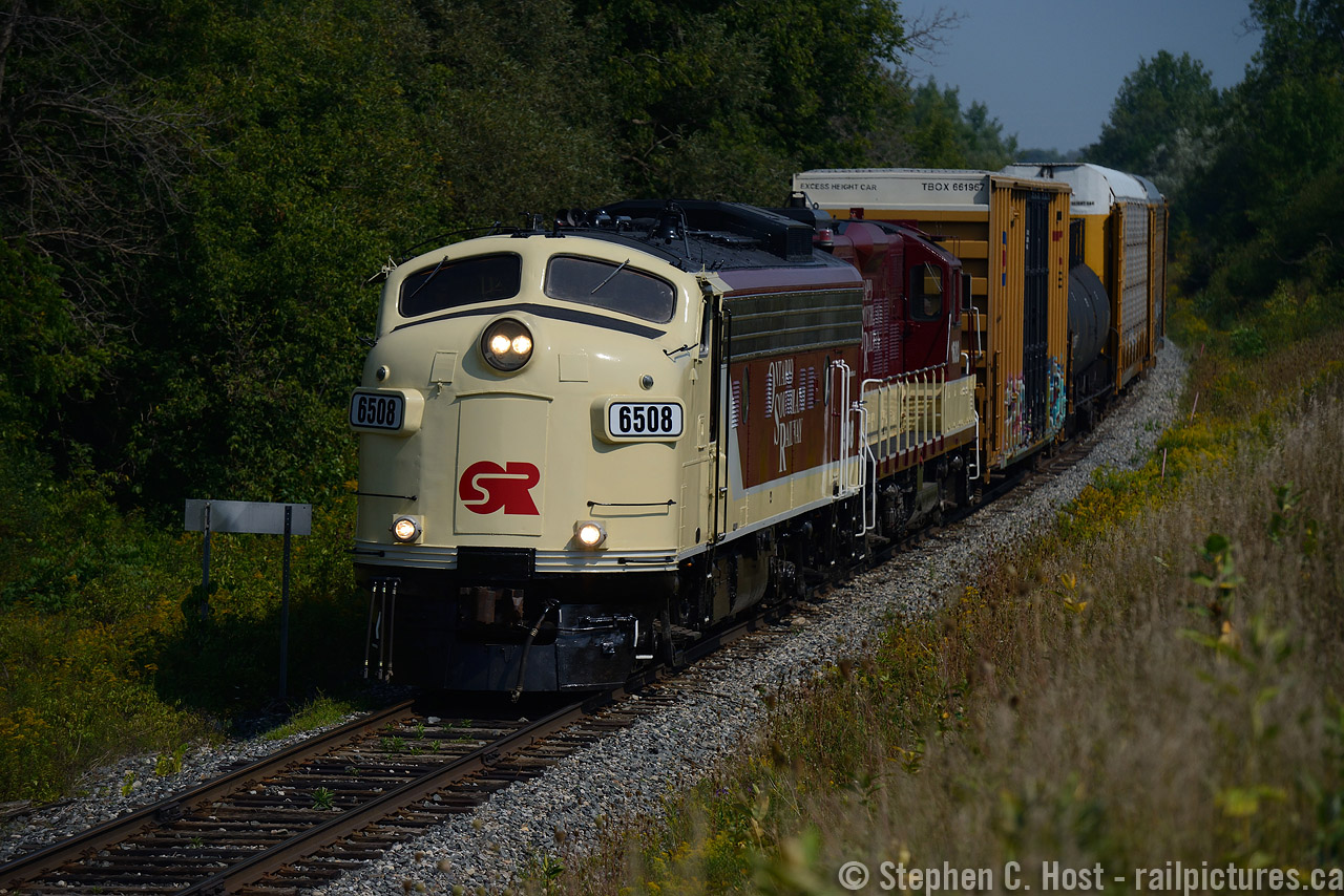 Looking Good 6508 leads the first round trip of todays Woodstock turn at the Ingersoll 1 mile marker just outside of town limits with 30 cars of mixed traffic in tow. Honestly, in this humble photographers opinion, 6508 looks even better in active service than sitting at the shops at Salford. Why the first round trip? OSR made two round trips to Woodstock today, ran light to Woodstock from Salford between 10 and 11, lifted 30 or so cars, west from Woodstock around 11:15 AM, with work at Beachville, Ingersoll, and a final set off of 14 at Cami. Then the boys lifted more from Cami, ran back to Woodstock and set off at W. Coak later in the afternoon. Naturally, this means two round trips were completed and all done by 3:45 PM.
I'd say 6508 can hold a candle to Christopher Wasney's shots of the Royal Canadian Pacific uploaded earlier today... I'm glad we have FP9A's in service in 2015, better get 'em while you can!