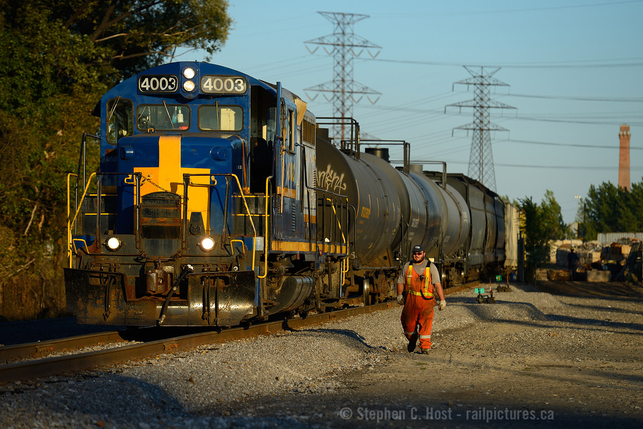 Summer's officially over as of tonight, and in the last rays of a late Summer sun, SOR 495, aka 1900 HAM yard switcher is at the far end of the "hole" - Parkdale Ave in Hamilton switching A&M metals. The Conductor (and RPCA member angelok) is walking up to the train after coupling cars to perform switching in the yard behind me. This is a place I have been to numerous times since 1998, first as an employee of a local metals recycler (summer job) later, as a railway and Hamilton enthusiast, these gritty dusty areas are what I like the most and where I spend a lot of my photography time. I'm a Hamilton fan, and the North End is where it's at.
Note the recent right of way work - A&M is expanding rapidly and it would appear a new spur is to be placed in the graded area at right - A&M is up to about 10 to 20 cars a day  and now sports a red Trackmobile.