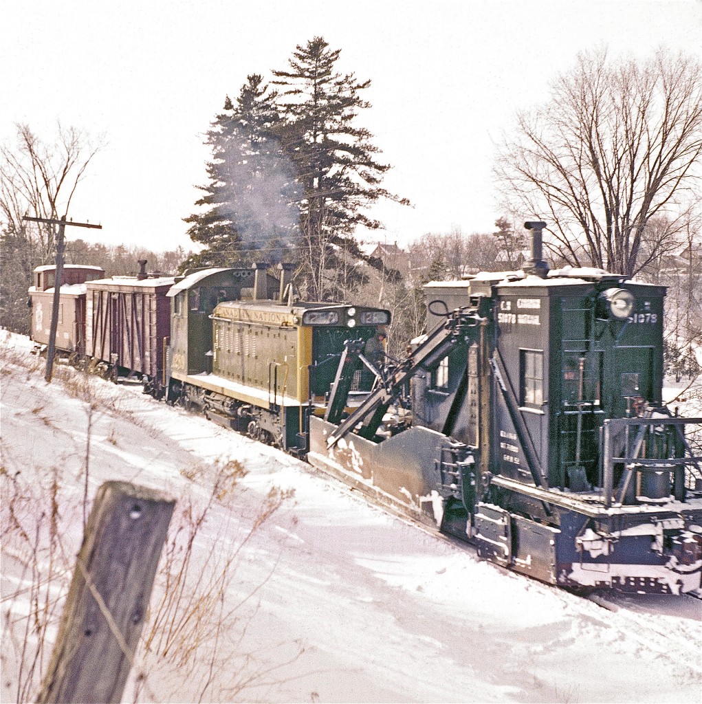 Pity the poor fellow standing on the front of EMD SW1200RS #1289 on this winter's day.

This image was taken circa 1960.  There was quite a bit of damage on the original slide.  I hope that you'll agree that state-of-the-art digital scanning and a touch of Photoshop has restored the image to acceptable standards.

Del's sister, Gloria, recently mailed me a package of Del's writings and historical Pembroke notes.  Turns out he had a rather mischievous sense of humour.  If he were still with us, I'm confident that he'd be delighted that his images are being viewed and enjoyed.