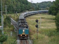 Having learned that VIA No.1 would be departing Toronto at 0900 (it's old departure time), due to the late arrival of VIA No.2 the previous evening; I wanted to try and recreate a shot of No.1 at Falding from 2007.
http://www.railpictures.ca/?attachment_id=803

Alot has changed in the 8 years between these photos. VIA has rebuilt their fleet of F40's, making the bright yellow and grey units a thing of the past.  The schedule for No.1 and No.2 has been drastically changed, with time added in an attempt to increase on time performance, resulting in a 2200 departure from Toronto.  It takes 8 hours to turn the train and when they arrive 10+ hours late, we get a rare daylight treat like this.  

Things have changed on the CN side as well.  The 6120' passing track at Falding is now a stub ended storage track, with the south switch being ripped out about a year ago.  Signal 1428 now protects a glorified location for Foreman and work trains to clear; maybe the odd hot box set out if required.  Due to the short length of the siding (6250feet is considered siding length) and being located on a 0.3% - 0.8% southward grade the siding was rarely used, except by well powered and short trains.  Not to mention, the siding was located 4 miles from the "double track" provided by the Directional Running Zone with CP and given the gradient, it was a risky meet location.  

While much has changed, some things have remained the same.  The classic shot from the overpass at Rankin Lake Road still provides a clear view of a northbound sweeping through the curve, with the old siding track swinging eastwards around some rocks and a pond.  The old searchlight signal remains, warning of approaching trains and protecting the old siding track.  Last, but not least, it is still impressive to watch VIA's the Canadian streak through Muskoka with 25 gleaming stainless steel coaches, diners, sleepers and domes as the engineer provides a friendly wave.
