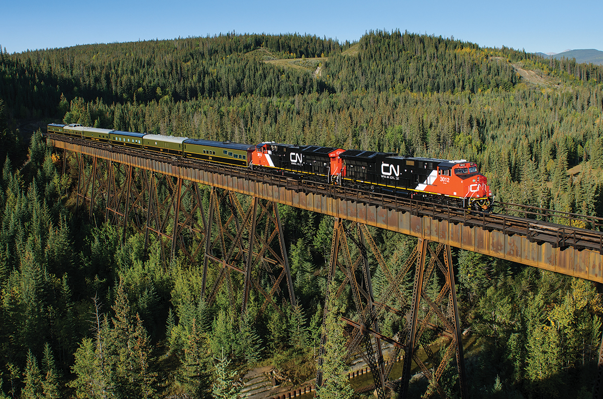Brand new CN ET44ACs 3012 and 3013 speed across the Prairie Creek with a Board of Directors special. The train ran from North Vancouver to Edmonton via Prince George.