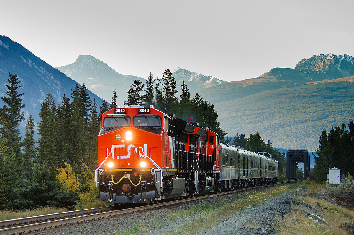 CN ET44ACs 3012 and 3013 speed across the Snaring River at Henry House with Edmonton bound train P617.