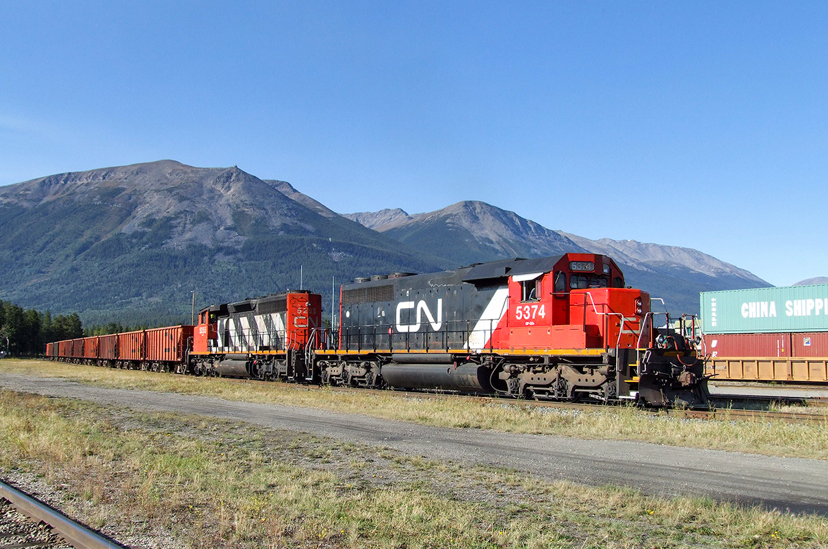 CN SD40-2 5374 and SD40-2W 5255 (both units now retired from CN's roster) pull into the south yard at Jasper with a loaded ballast train from Giscome, BC.