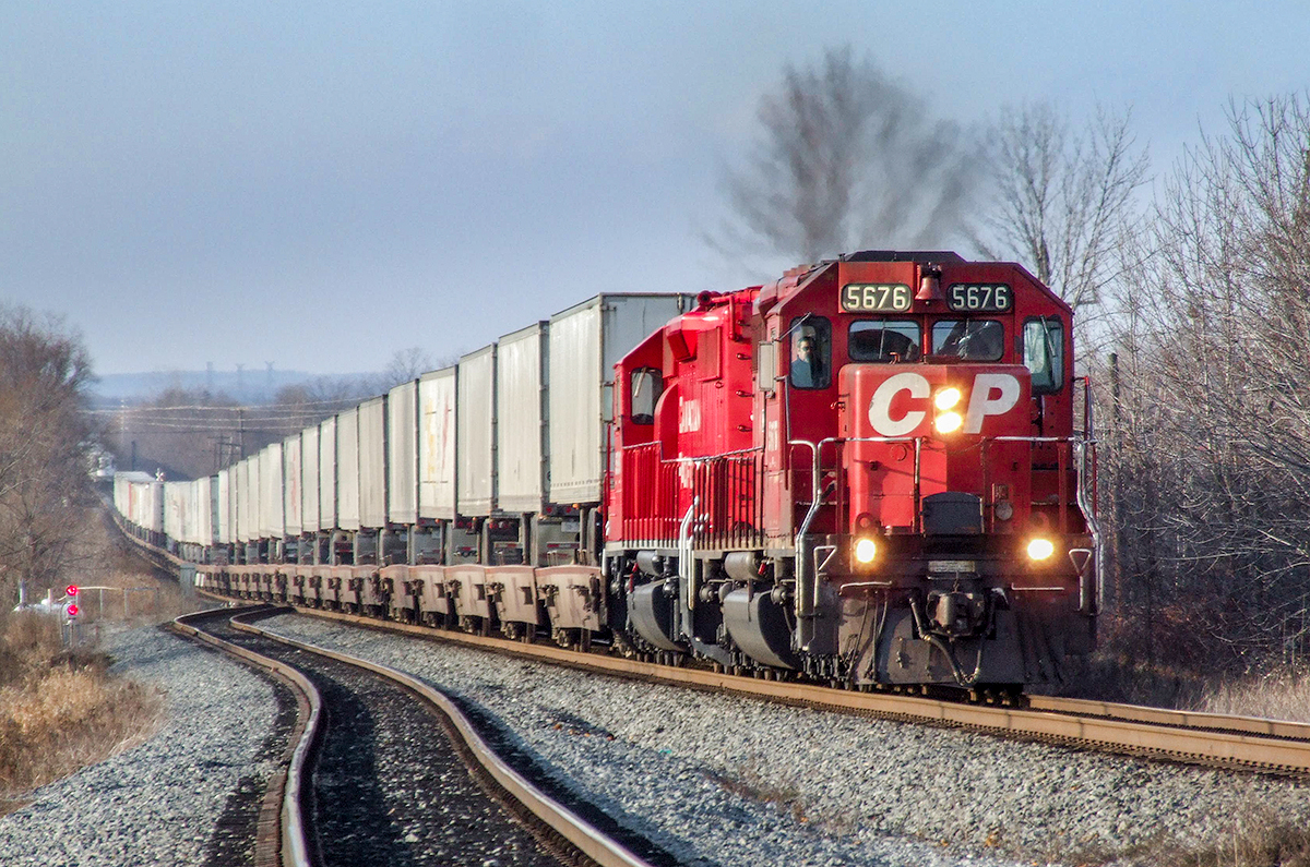 CP SD40-2s 5676 and 5990 hustle train 122-17 eastward down the main at Oshawa on CP's Belleville Sub.