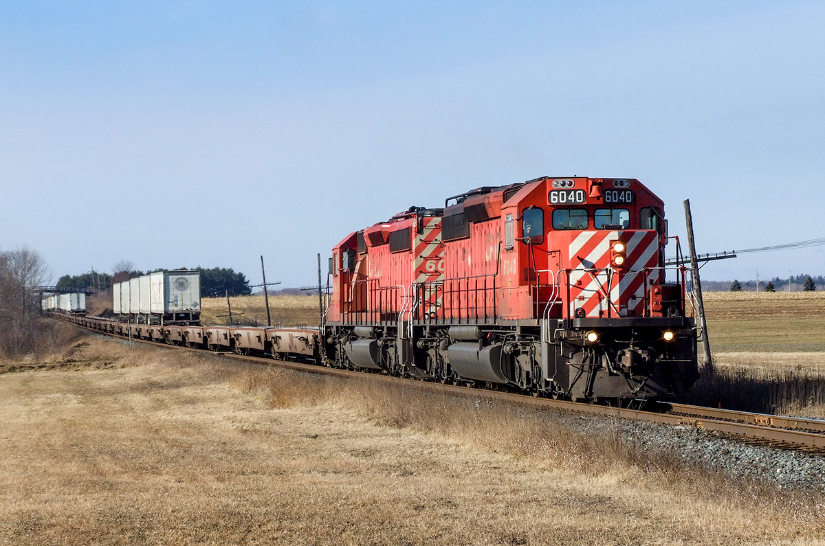 CP SD40-2s 6040 and 6039 hustle one of the 2 daily eastbound eXpressway trains through the farmlands east of Bowmanville on the Belleville Sub.