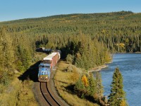 In sweet, evening, golden light, IC 2460 tips over the hill at Solomon along the shores of the Athabasca River with train A417.