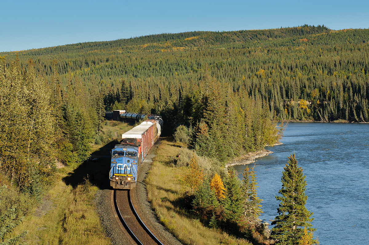 In sweet, evening, golden light, IC 2460 tips over the hill at Solomon along the shores of the Athabasca River with train A417.