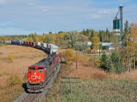 Southbound in perfect light, CN 112 glides through Mount Albert in the array of fall foliage.