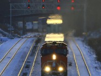 Late afternoon on a bitterly cold winter day with the short winter light disappearing..CN 148 heads up the grade eastbound through Snake.