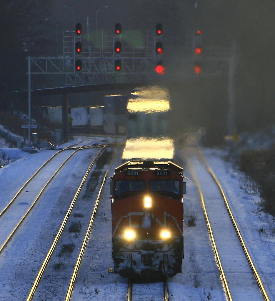 Late afternoon on a bitterly cold winter day with the short winter light disappearing..CN 148 heads up the grade eastbound through Snake.