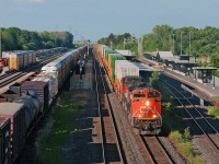 With the economy slowing down, trains have been either getting cut or getting somewhat shorter, and rail yards a bit empty. CN 149 rolls down track two by Aldershot with 9,007 ft on the drawbar bound for Chicago. Off to the left, CN 551 is parked for lunch down towards the lower yard. 