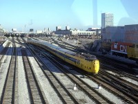 This is my only picture of the Turbo train. It is obviously taken through a plate glass - a window on the CN Tower foot bridge. 
The view most likely captures the train heading back to the barn after coming in from Montreal 
It is probably the only train set that looks handsome in the yellow and blue paint of VIA rail. Photo was taken around 1400hrs.