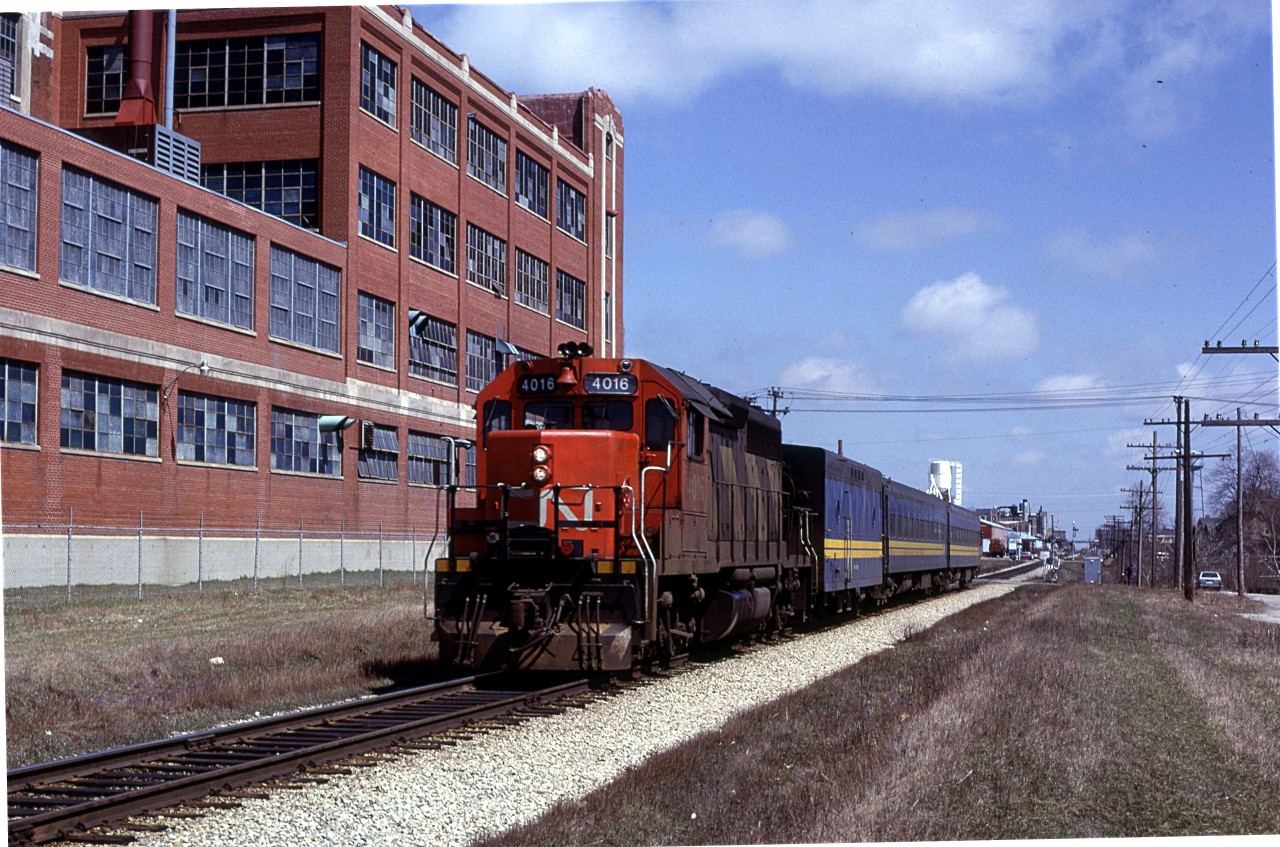 The high speed CN GP-40's became the regular power on the noon hour westbound VIA train. It would be led by 4016 or 4017.
The Art Deco building in the background is a tire manufacturing outfit.