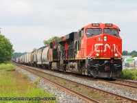 <b> HAPPY CANADA DAY! </b> Lead CN engine 2938 (with CN 2837) pull this large mixed freight eastbound approaching the Railway Street crossing. In the background is Lind Lumber Yard, which has through the years overtaken the old Dorchester station site.