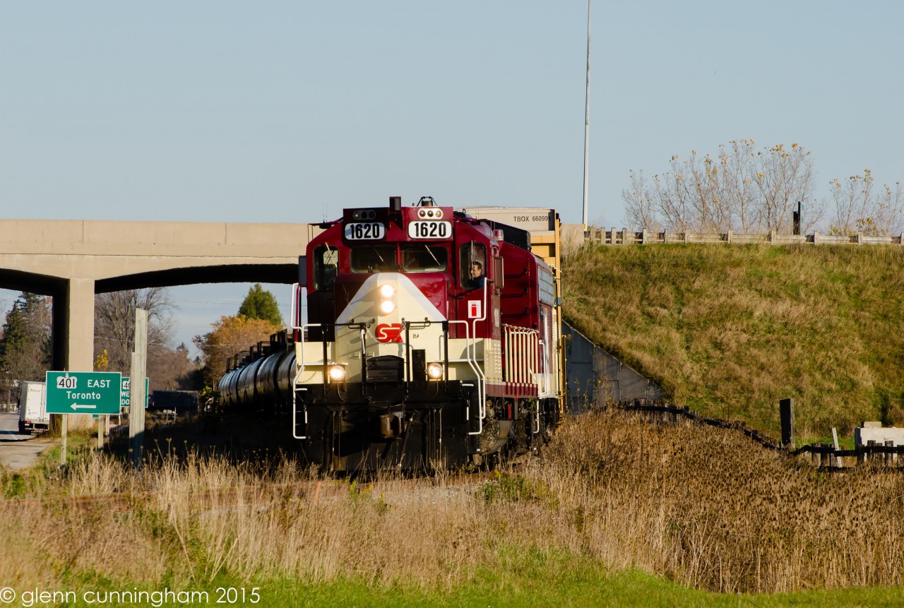 OSR 1620 and 6508 head under Hwy 401 and are about to cross Putnam Rd on with a box car for Messenger Freight Services and some tanks for Factor Gas Liquids.