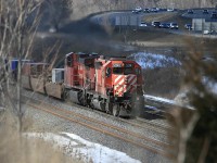 With a little over a year to go before the CP trackage rights on the CN Oakville Sub came to an end...CP 255 is barely off CP trackage when the ditch lights dimmed and he slowed to a stop at Waterdown. Shot from atop the "berm" with Hwy 403 in the background