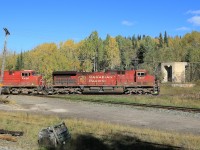 9607 leads an eastbound 100 series train over the diamond.  To the right of the train is the foundation of the old water tower that hints at busier times here years ago.