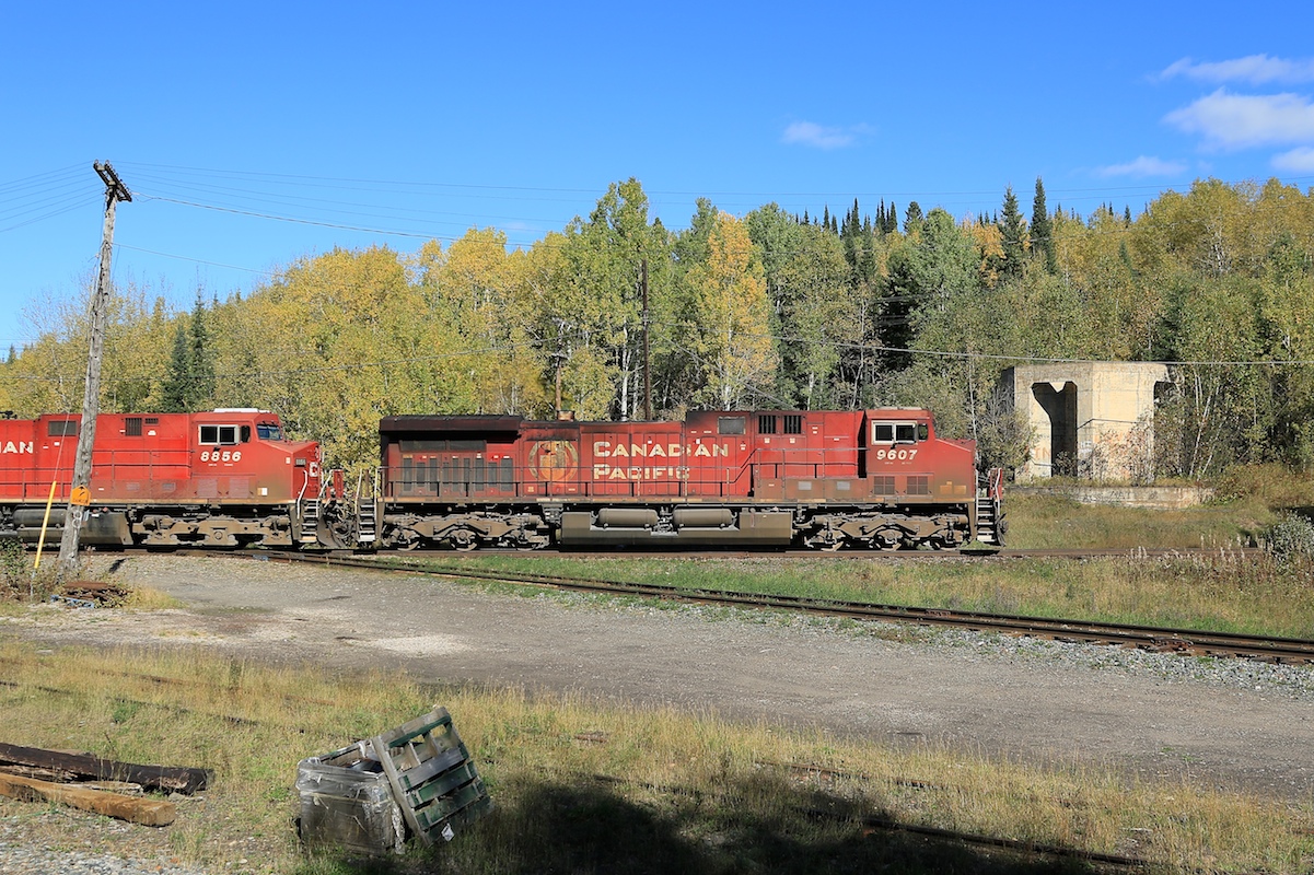 9607 leads an eastbound 100 series train over the diamond.  To the right of the train is the foundation of the old water tower that hints at busier times here years ago.