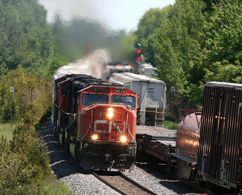 It looks like just another CN train with an everyday leader....however there was much more than meets they eye here....CN 369 with the 5773 leader is passing eastbound 376 looking east to the Newtonville crossovers...at this exact moment....a westbound on the CP lead by CP 5773 was also passing by.....however its train met a fate a short time later in Oshawa..see 
http://www.railpictures.ca/?attachment_id=14687