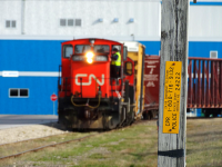 On a former piece of CPR trackage, CN 1401 and 7044 work the local job in Fort Garry, Winnipeg. The crossing here still has the CPR emergency sign on it, allowing for an interesting shot of CN on "CPR".