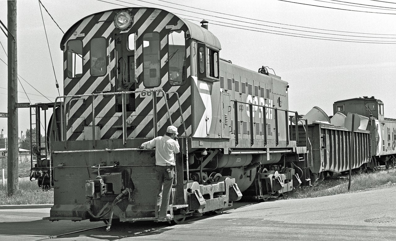 Daniel Odette recently posted a set of great night shots.  His last image captured some industrial railroading in the “Golden Mile” area of Scarborough.  (Daniel and I nearly bumped into each other - except we were about a mile and 40 years apart)!  My photograph was taken at the corner of Bertrand and Thermos Avenue.  It was part of the Scarborough Industrial Spur which was removed in ’94.  This is my third and final shot from this sequence.  That is my friend, Terry, riding shotgun in the cab – I'm not sure that his smile could have been any bigger.  We were about 14 at the time and gladly accepted the engineer’s kind offer to ride with him for a bit.  Our biggest concern was whether our bikes would still be there when we got back (they were)!


Here’s Daniel’s terrific photograph…



http://www.railpictures.ca/?attachment_id=20808 




In case you are interested and missed my earlier postings, here they are again.  In the Comments section, Mr. Dan and Mike Lockwood added some great insight into this long-gone piece of track (including a link to a detailed map)…   



http://www.railpictures.ca/?attachment_id=18762 


Here's the engineer...


http://www.railpictures.ca/?attachment_id=19333