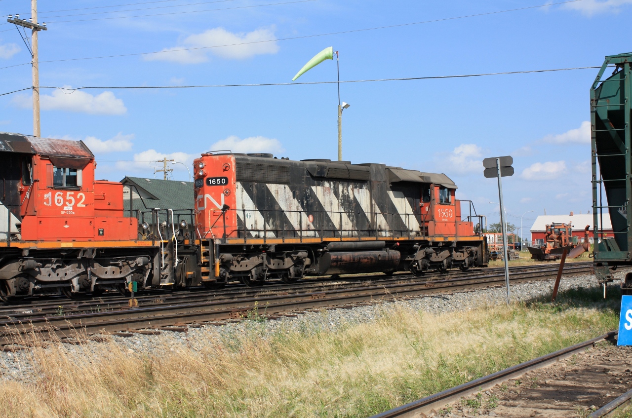 Always found some CN or CP action in Lloydminster AB each time I took my family shopping there. This time I drove over to the CN yard office. CN 1615 was sitting there with the shady side exposed, so I drove around to the south side of the tracks in order to get near the sunny side of the locomotive. The locomotive was a little long in the tooth but she seemed to really jump when starting to pull a string of oil cars. Nothing like talking to the CN police while taking pictures!
