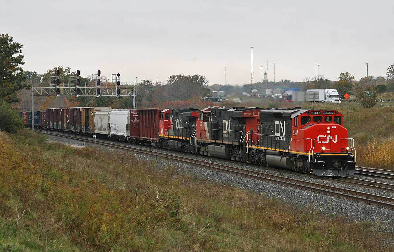 Flat Rock to Toronto train M 38461 20 throttles up as they begin to climb out of Bayview and up the grade to Aldershot.  384 was slated for an early morning trip through south western Ontario, however were delayed for a few hours at Port Huron due to 383 having a broken knuckle in the Sarnia Tunnel.  After a 12 hour night shift at work, it was worth heading home to grab my camera and waiting trackside with a coffee to catch a veteran SD40-2W doing what it does best.  M 38461 20 had freshly painted CN 5347, CN 2261 and CN 2515 dead in tow, it was also the first of 4 trains through the area in 30 minutes.