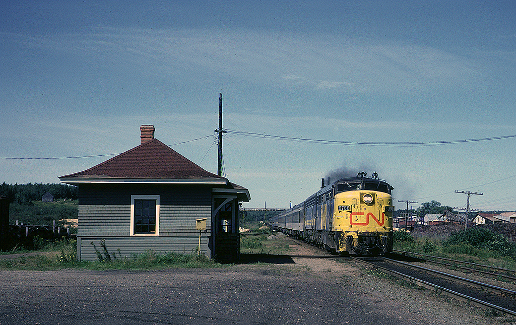 A few minutes after making its station stop in Truro Via #12 blasts past the station in Brookfield, Nova Scotia. FPA-4 6768 is wearing the early Via Rail paint scheme with the yellow pilot, angled yellow paint on the side of the nose and the CN logo on the nose.