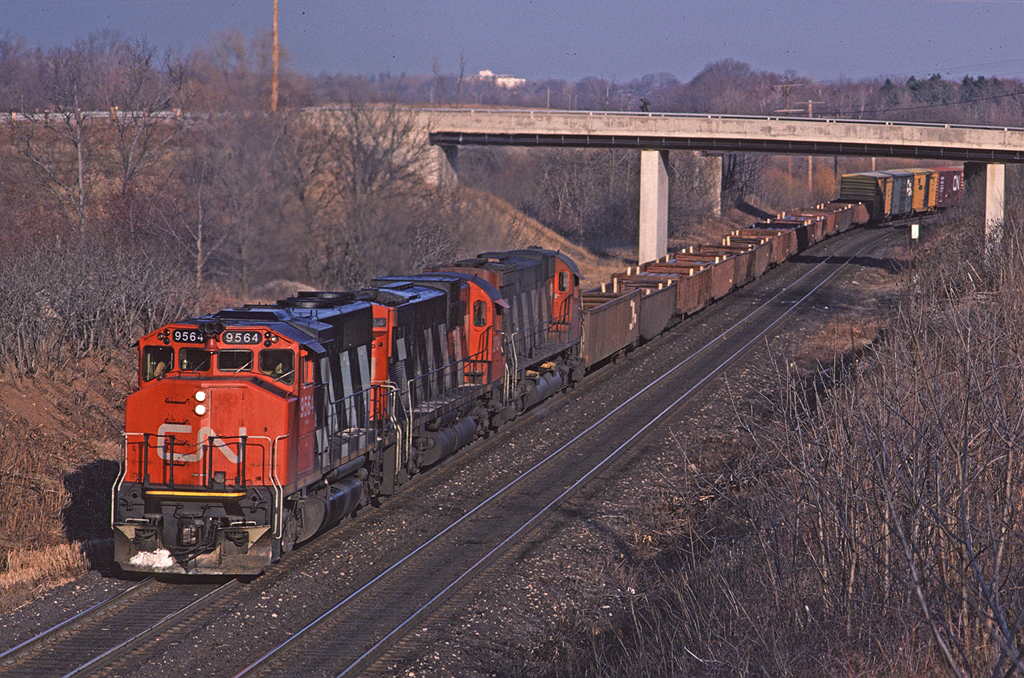 Two out of three ain't bad! CN GP40-2W 9564 leads Toronto - Sarnia train #425 up the grade from Bayview, passing under the RBG footbridge near Mile 1 on the Dundas Sub. Train #425 was a regular mid-afternoon train on the Dundas Sub.