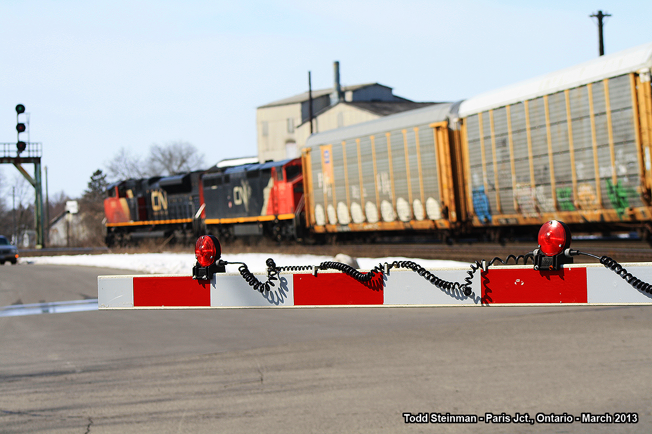 LIGHTS...CAMERA...ACTION!!!  At the Market Street crossing, there were plenty of lights halting traffic as this westbound freight rolls around the bend through Paris Junction, mostly hauling auto racks in it's consist.