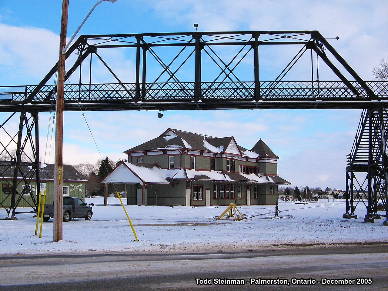 Standing across from William Street on what used to be the Canadian National Newton Subdivision...the Palmerston divisional station and iron foot bridge that once helped pedestrians cross the busy yard now stand still. The station was restored around 1996 - and is now the Palmerston Heritage Railway Museum (well worth the visit). The foot bridge had extensive restoration to it as well around 2010-2011. Lines used to sprawl out with trains carrying passengers to Guelph or Hamilton in the south, to Harriston, Owen Sound and Wiarton to the north, as well as to other places like Durham, Southampton, Listowel and Kincardine. Now the station and bridge sit silent - frozen in time yet well preserved.
